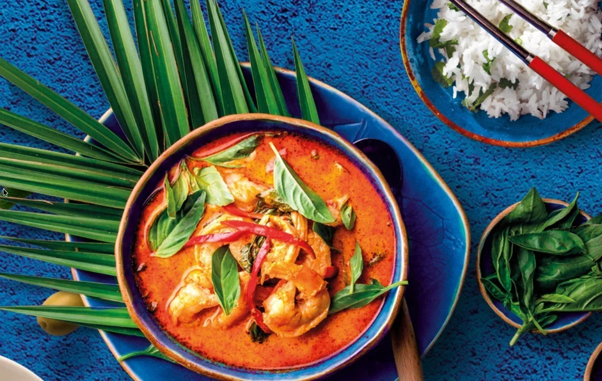 A Thai curry with rice and basil, plated